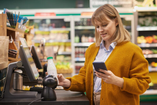 woman at self-checkout in grocery store