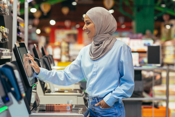 a woman buyer in a supermarket using self checkout