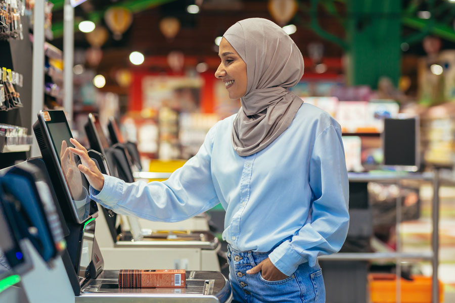 a woman buyer in a supermarket using self checkout